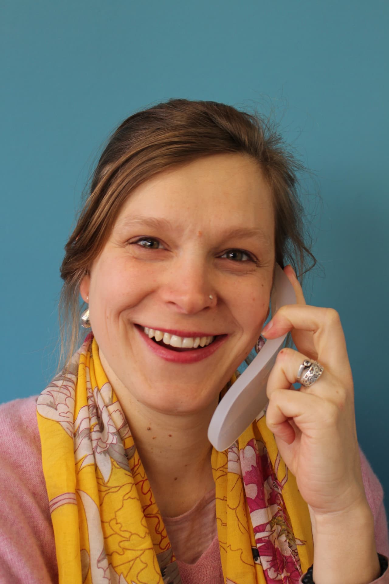 Teammitglied hält eine Aktiv-Einlage ans Ohr wie ein Telefon